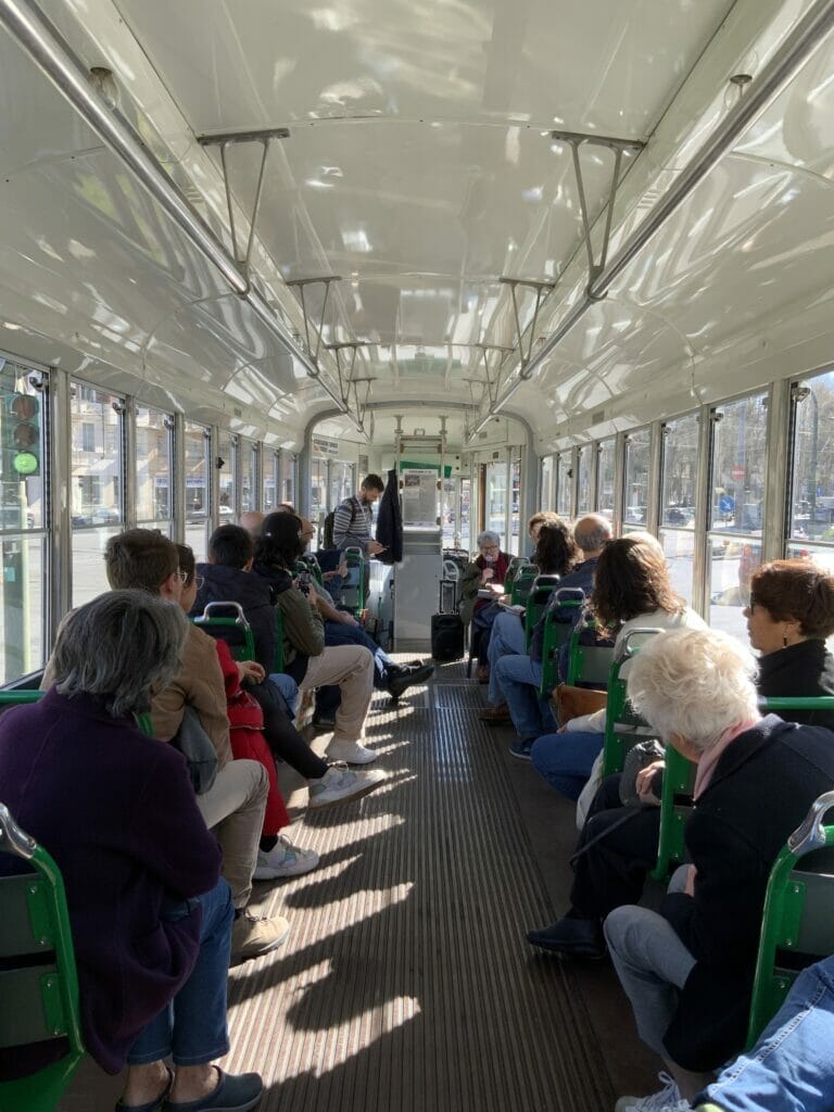 People listening to poetry reading on a tram in Turin